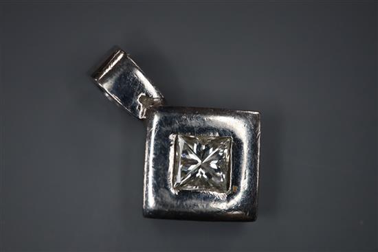 A white metal (stamped plat) and princess cut diamond set pendant, overall 18mm.